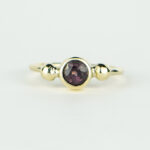 Handmade 14 karat gold ring with burgundy spinel and ball details